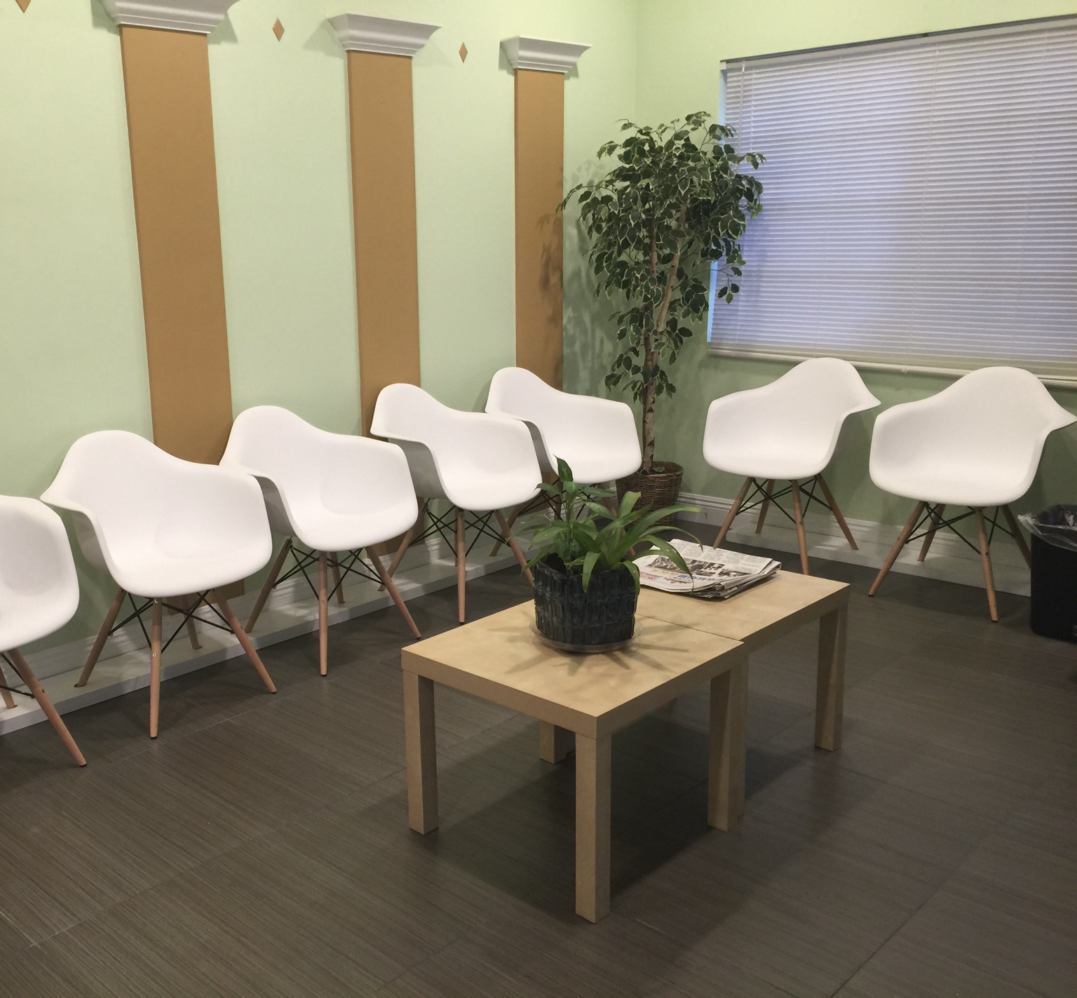 Greenfield’s waiting room with white chairs and plants